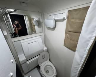 nucamp truck camper bathroom with shower, toilet and flip down sink