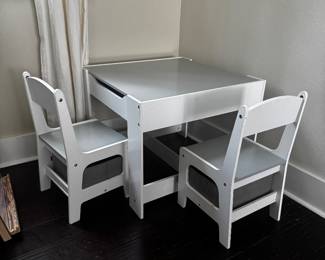 Kids Table & 2 Chair Set with Storage  $50 OBO  Perfect for arts & crafts, coloring, puzzles, homework, or snack time! This sturdy white children’s table comes with 2 matching chairs, each featuring built-in fabric storage bins for books, toys, or art supplies. The table also has storage space built into it under the table top.   Features:  * White / gray kids table with built in storage  * 2 matching chairs with built-in fabric storage bins * Great for crafts, reading, learning, and playtime * Sturdy and easy to clean * table top does have some marks, but nothing on the table is broken   Perfect for toddlers and young children.   Keywords: kids table, toddler table, children’s desk, activity table, play table, craft table, homeschool, Montessori, toy storage, playroom furniture.