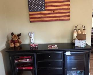 Black Media Console with Glass Doors and Wooden American Flag Wall Art