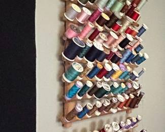 Vintage Wooden WallMounted Thread Rack with Assorted Spools