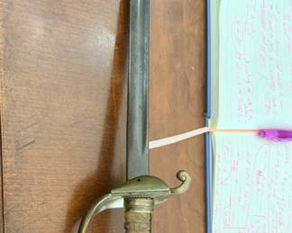 This Model 1860 Staff & Field Officer's Sword variant is identified by its distinctive floral-patterned guard and matching rosette pommel cap. It represents a widely carried sidearm pattern famously used by Union Army staff and general officers during the American Civil War, as well as by state militia officers in post-war eras