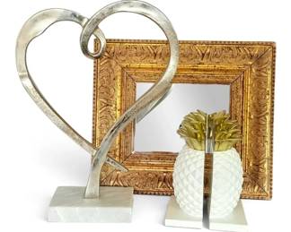 Small Mirror With Gilded Frame, Pineapple Bookends, And Metal Heart Decor