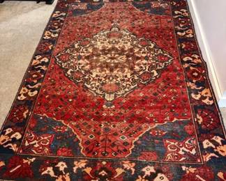 Dimensions:5x8  Description: Persian, possibly Sarouk-Farahan rug. Hand knotted 100% wool.  Design: Central medallion surrounded by a traditional floral pattern Color: Deep red, navy, gold, beige and blue. Possibly colored with natural vegetable dies Price: $300	