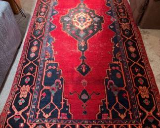 Dimensions: 10’ 2” x 4” 9” Description: Hand knotted, 100% wool, Afghan Turkman wool runner Design: distinctive small scale geometric medallion surrounded by tribal motif.  Color: deep red, navy-multi Made in Iran, providence Hamedan Price:  $350
