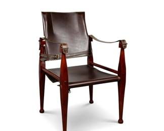 Bridle Leather Campaign Chair A sophisticated accent chair that promises to transform any space. This piece, brand new and is still in its original box from Authentic Models.  Rich, real leather upholstery. The classic design is ready to infuse your study, den, or bedroom with a polished, inviting atmosphere.  This luxurious piece will bring a touch of genuine craftsmanship into your home.  Price: 4 chairs available $700 each, new, 2 in the box.