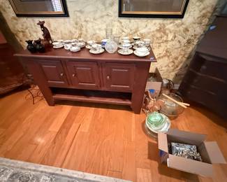 Sideboard with various china pieces and decor