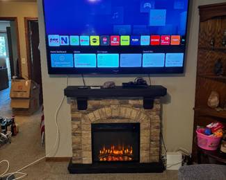 Nice plug in fireplace 65” LG flatscreen