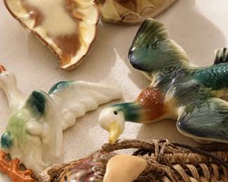 A fun assortment of quirky ceramic pieces, wall hangings, figurines, planters, and other unusual decorative finds.