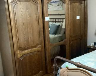 Solid oak from England ward rob.  Hanging rods on each side,middle door with shelves.