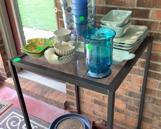 Tall metal leg table with glass top.