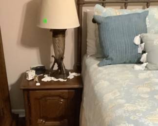 End table by cast iron bed. 