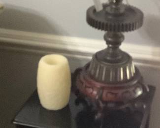 The small black end table with mechanical made lamp.