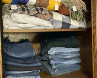 Quilts and jeans in the wardrobe.