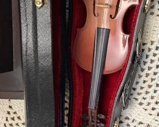 Small violin in case.