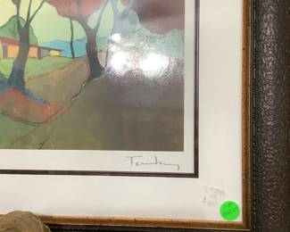 Close up of artist signature on picture over mantle. 