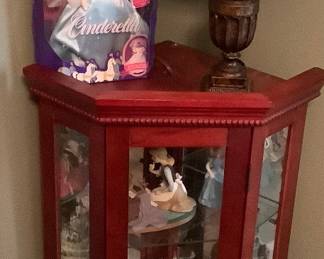 Small lighted glass cabinet with Disney characters.