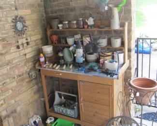 Gardening Bench and the patio ha plenty of pots
