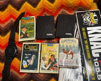 Just a few of the Zippo lighters and collectible Camel items 