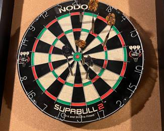 Dartboard with cork backing. Comes with two sets of three darts each. 