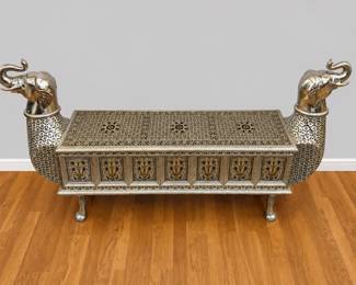 One of a pair of heavily clad silver tone over wood bench elephant heads