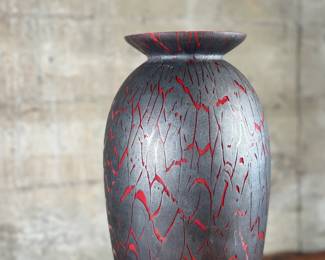 This lot features a stunning Italian glass vase with a lava effect by Dolbi Cashier. This vase measures, 20” H. Dolbi Cashier Italian glass vases, produced around 1993, are highly collectible pieces of art glass. They typically feature vibrant two-tone color palettes, like seeded aqua glass bodies with ruby red bases, and are known for their controlled bubble (bullicante) technique and statement silhouettes.