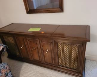 Fischer Statesman record player/radio with storage for records. Some records included. Does play records but can barely hear the sound