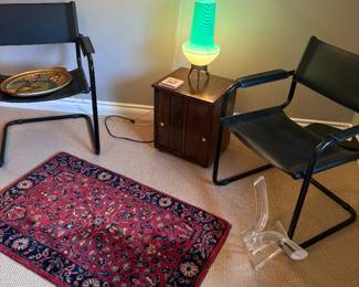 Another view of the black and leather armchairs, hand-made 100% wool area rug, side table with MCM lamp