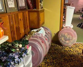 Wreath boxes with pairs of wreaths inside most. Artwork on ledge