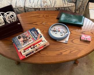 Coffee table, extension cords, remote holder, books, clock, bank bags