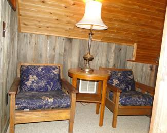 Comfy wooden chairs, and round table in between