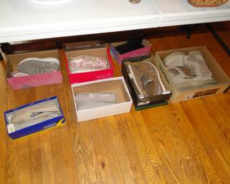 Shoes in boxes, never worn, on the floor