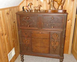 Tall antique dresser, with some horses on top