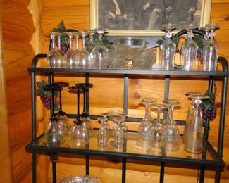 Glassware on a glass and metal bakers rack