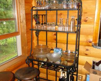 Tall metal and glass bakers rack that holds wine and other non bakers rack things
