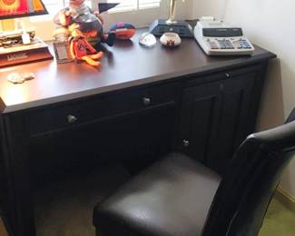 Sorry for the lighting this is a dark mahogany desk with electrical outlets & locking drawers