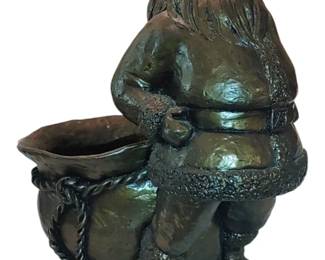 Large and heavy Santa sculpture holds floral arrangement