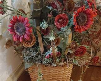 autumn-themed artificial floral arrangement features rustic red sunflowers, roses, and mixed greenery displayed in a woven basket.