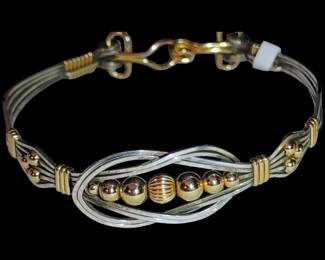 Ronaldo Designer Jewelry features a distinctive knot design accented with sterling silver and 14k gold-