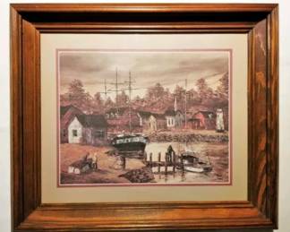 framed artwork is a vintage lithograph print titled “New England Fishing Village” by the artist Robert Lebron.