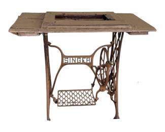 Several wrought iron Singer sewing machine legs some made into tables