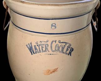 antique 8-gallon Red Wing stoneware water cooler featuring a blue wing stamp and side wire handles. this highly collectible crock likely dates between 1909 and the 1930s