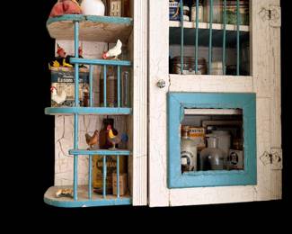 Unique wall cabinet filled with mini roosters and more collectible bottles