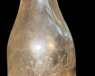 vintage, one-quart glass milk bottle from Inverness Dairy, which operated out of Cheboygan, Michigan. [1] (https://milkbottle.collectionhero.com/gallery_listings.php?keyword=cheboygan)The embossed lettering diagonally across the front reads "Inverness Dairy", with further markings below showing the location ("Cheboygan") and its capacity ("One Quart"). These clear, round glass bottles with sloping shoulders and small mouth finishes were common in the mid-20th century (often dating around the 1940s) for doorstep milk deliveries