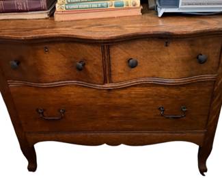 Three drawer oak chest with serpentine front