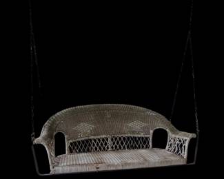 Antique wicker porch swing
