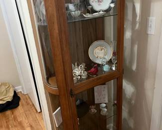 curio cabinet full of china and glass