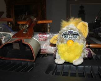 1998 "Banana Peel" Furby from Tiger Electronics, notable for its bright yellow fur and gray body.  It belongs to Generation 7 of the original Furby line.