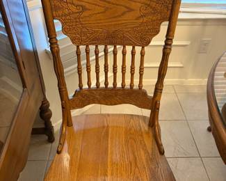One of a set of carved “country” style dining/kitchen chairs