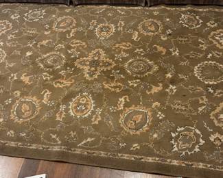 Very nice muted colors rug of beige, cru, and possibly olive colors if the lighting is correct