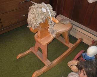 Amish-built solid oak rocking horse features a flat seat design and a thick, rope-style yarn mane.